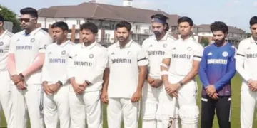 Players wear black armbands, observe a minute's silence