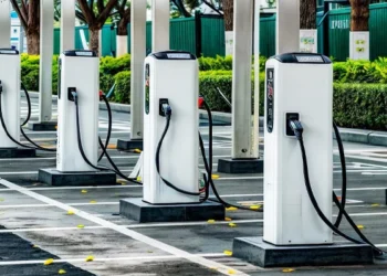 An electric car charging at a public charging point in India